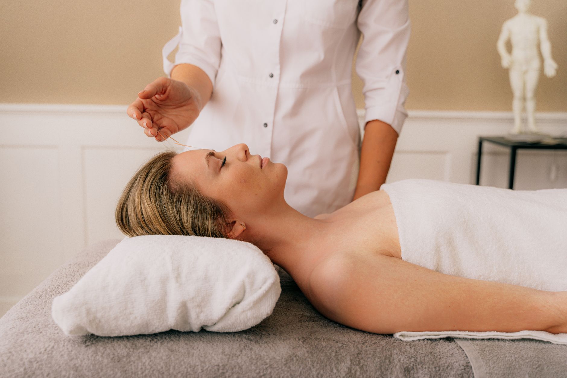 acupuncture session – calm treatment room with candles and soft lighting