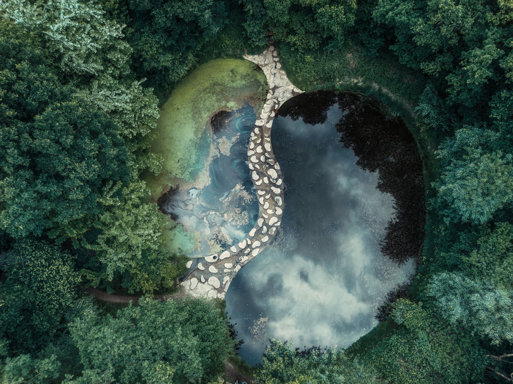 Yin and Yang – balanced stones on calm water symbolizing harmony.