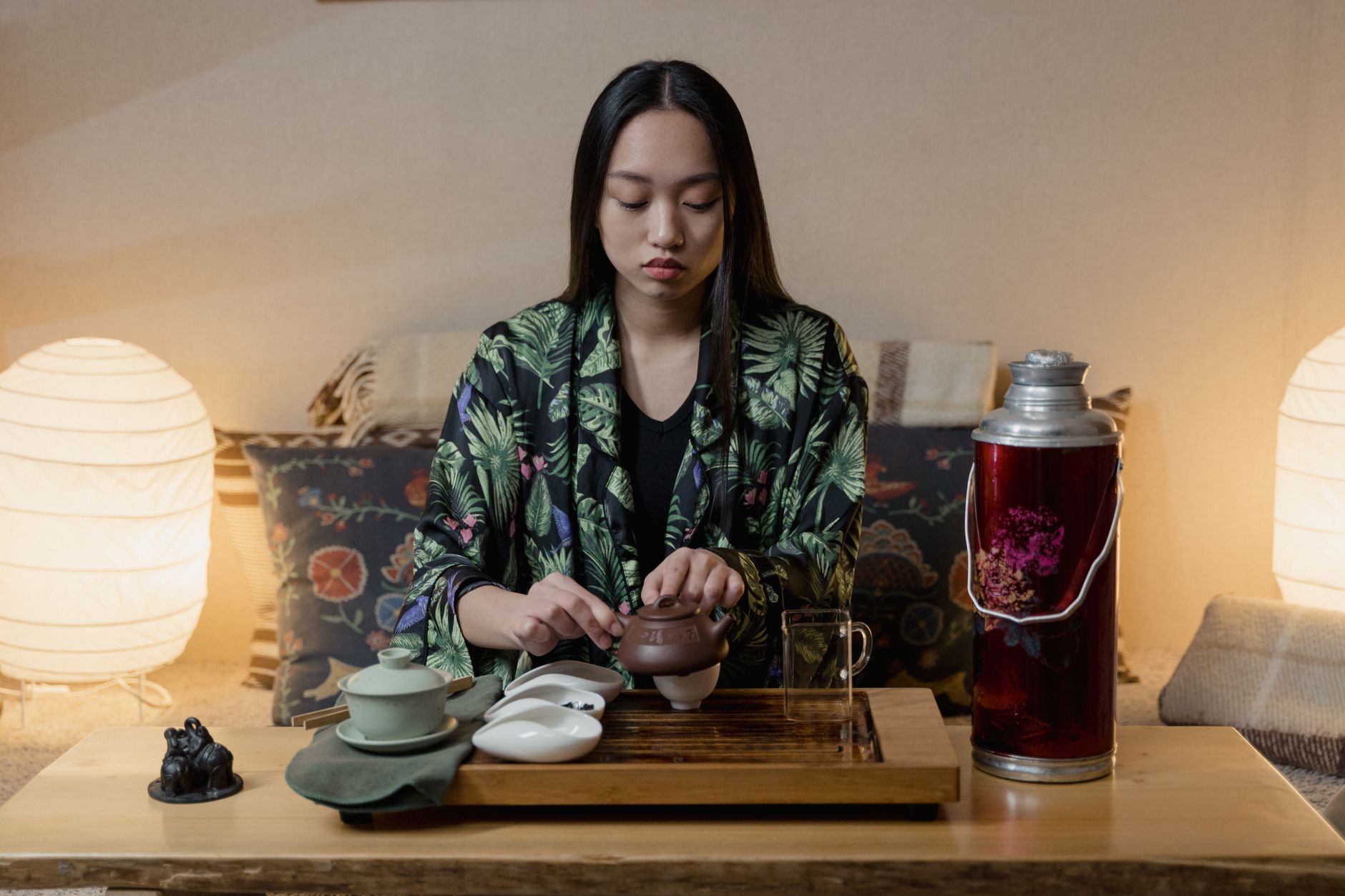 Chinese avoid iced drinks – woman drinking hot tea in cozy home.