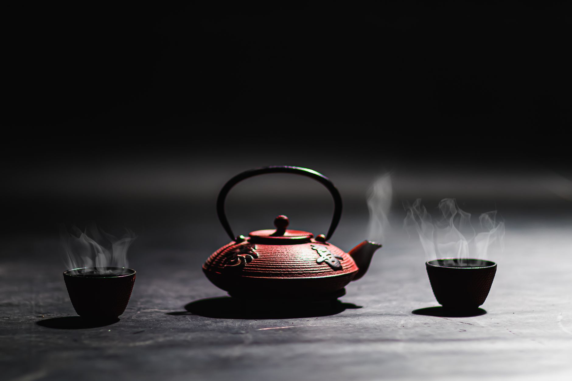 Chinese warm water – steaming traditional tea cup on a table.