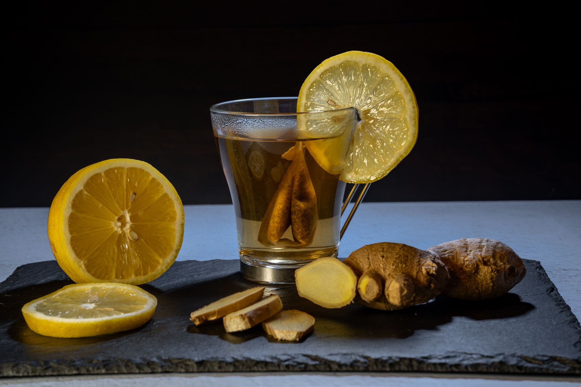 ginger warming TCM – sliced ginger steeping in a hot tea cup