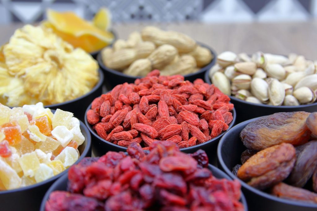 goji berries red dates TCM – dried goji berries and red dates in a wooden bowl