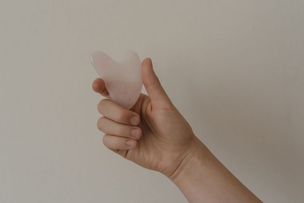 Gua Sha history – Traditional Chinese gua sha tool gliding across skin.
