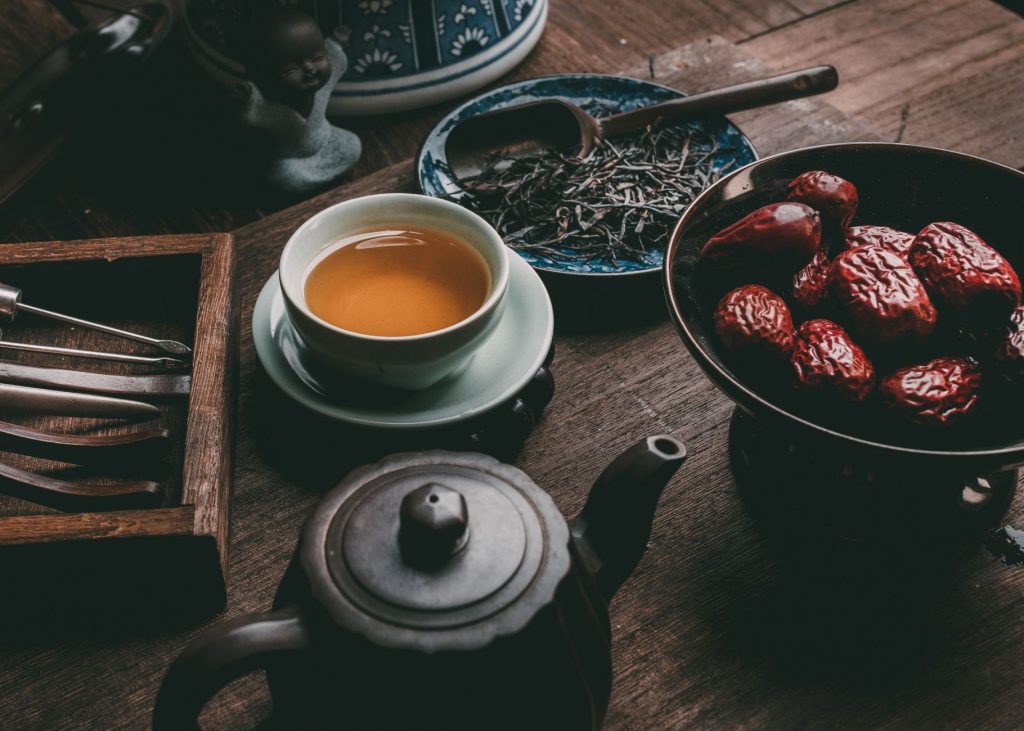 Chinese red dates – dried red dates on a rustic wooden table.