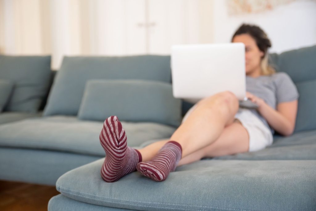 Chinese wear socks indoors – cozy living room, person relaxing on sofa.