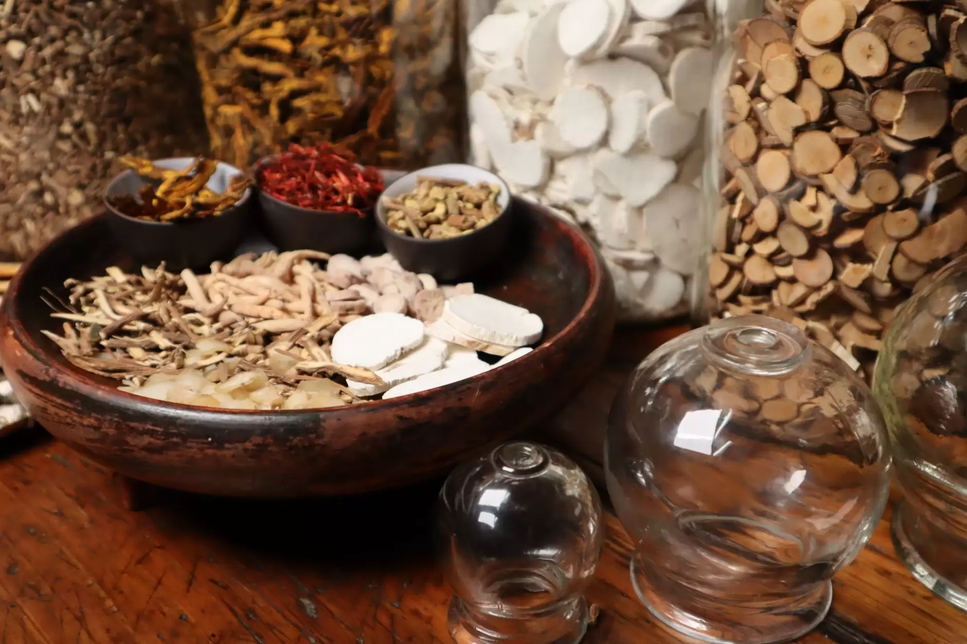 Qi in Chinese culture – dried herbs arranged beside a glowing energy symbol